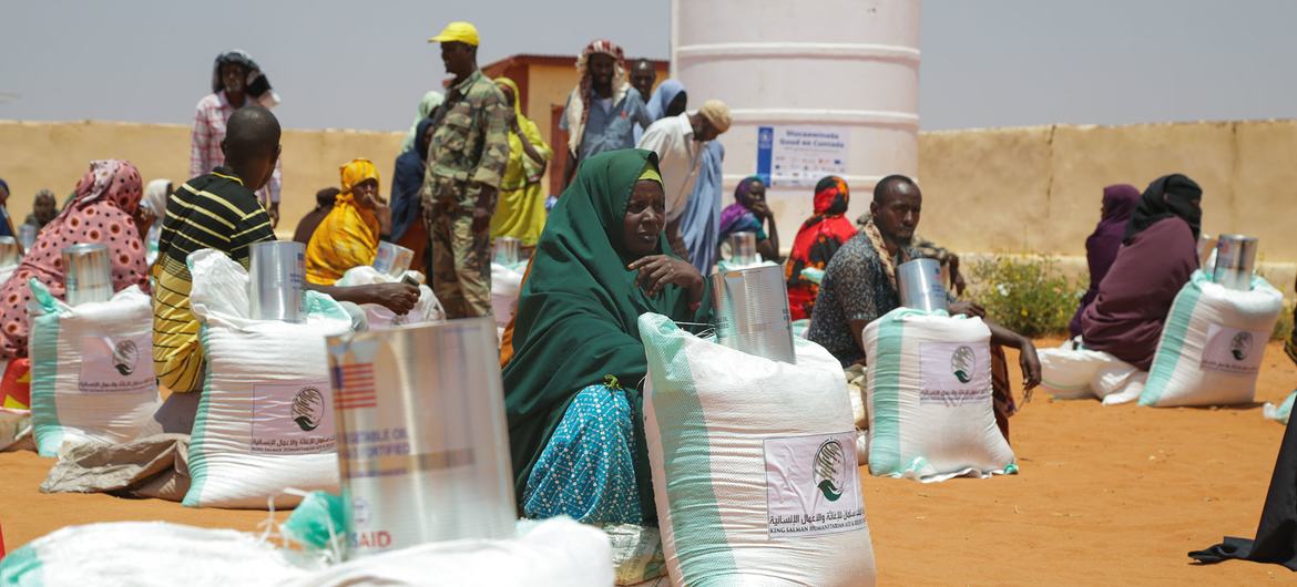 People sheltering at an IDP camp in Somalia receiving food aid.