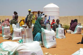 People sheltering at an IDP camp in Somalia receiving food aid.