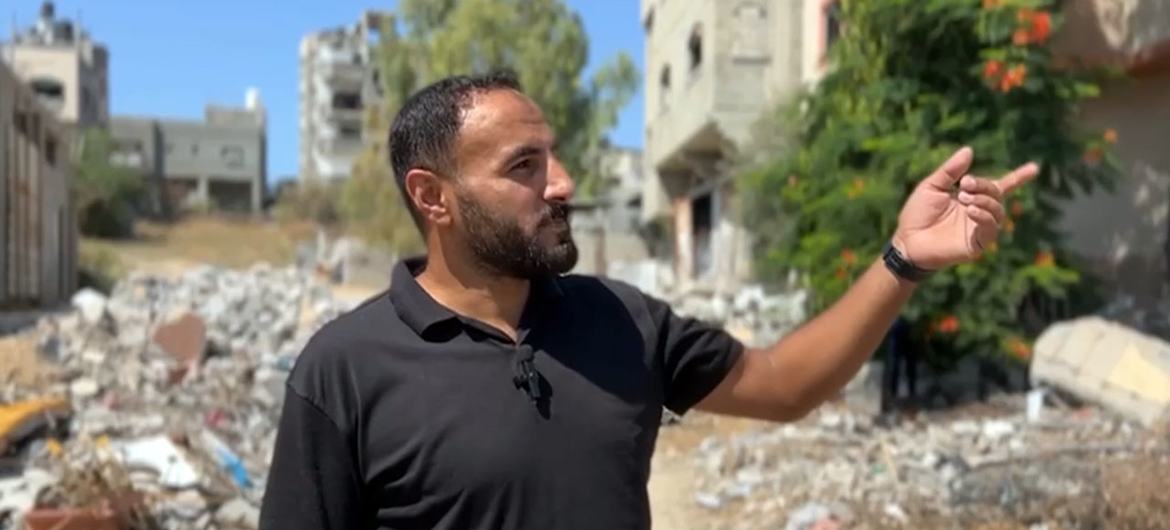 Ahmed Abu Aita points toward his house in northern Gaza, which has been reduced to rubble.