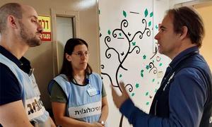 Dr. Michel Thieren (right), WHO Special Representative in Israel, talks to medical staff on his visit to the Barzilai Medical Centre in Ashkelon..