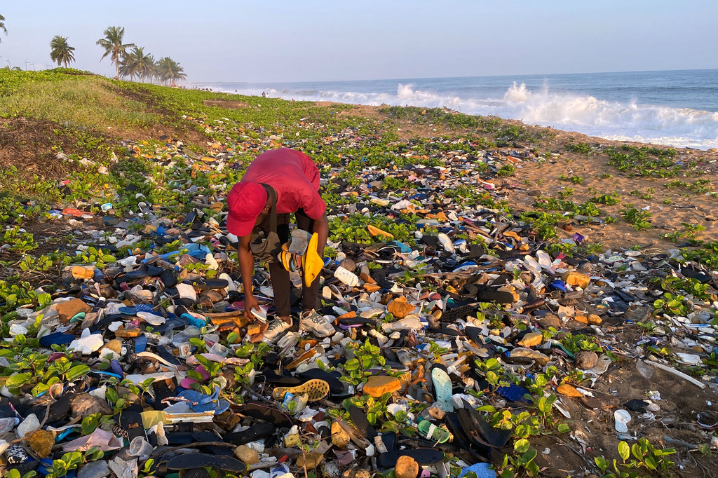 L'artiste Aristide Kouamé collecte des tongs échouées en bordure de mer à Abidjan, en Côte d’Ivoire.