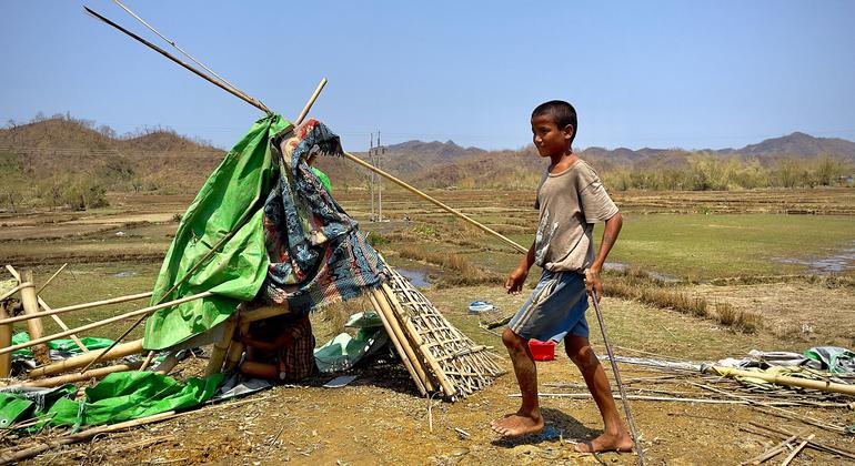 A displaced child prepares to dig a hole to set up a tent at an IDP site in Rakhine. (file)