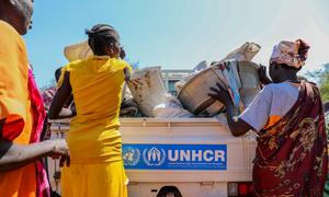 Displaced South Sudanese in Malakal load their remaining possessions onto a UNHCR pick-up truck to be transported to a site for internally displaced people. 