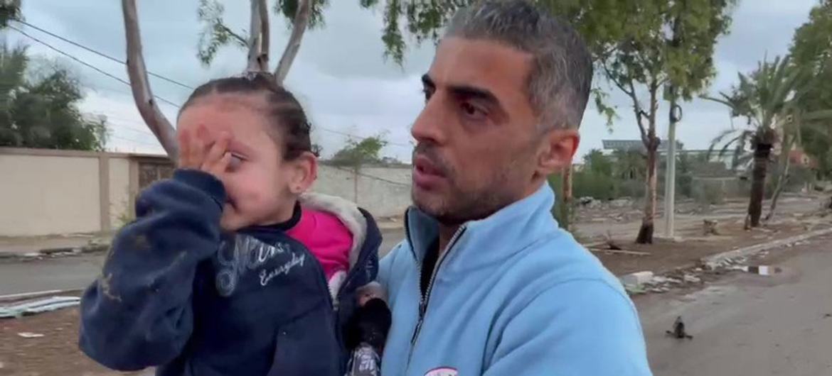 Mouhammed, director of emergency and disaster management at the Palestinian Red Crescent Society (PRCS) in Gaza Strip, assists in receiving a displaced mother and two daughters after crossing a checkpoint heading to the south.