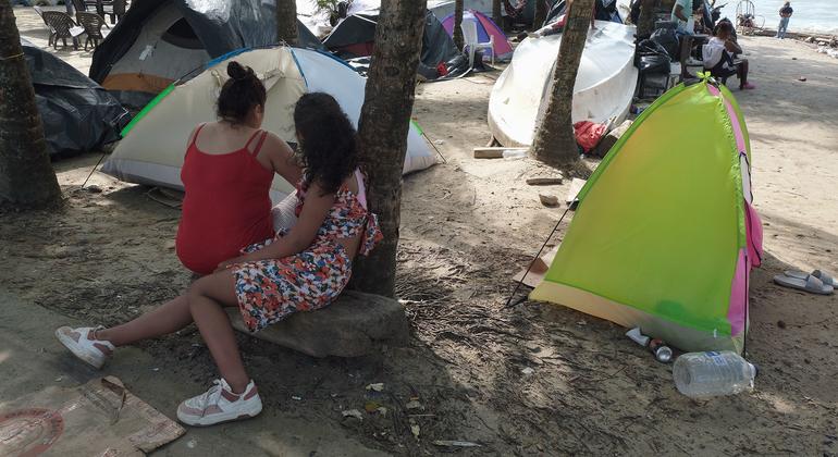 Families prepare to cross the Darien jungle camp on the beach in the Colombian city of Necoclí.