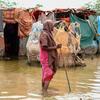 A woman wades through flood water in Hirshabelle State, Somalia.