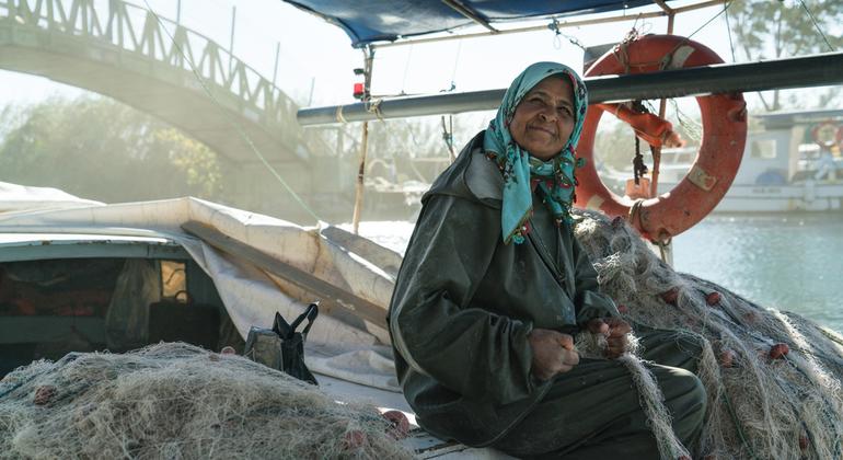 Mulher pescando em seu barco na Turquia.