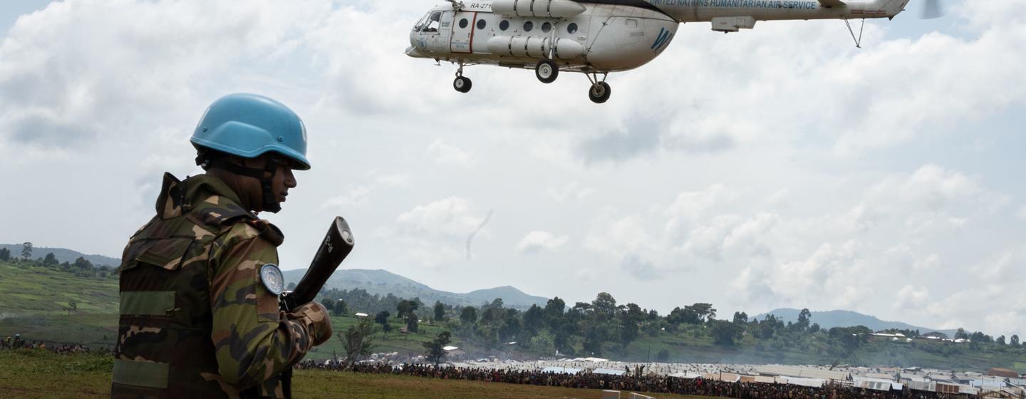 A UN soldier from the MONUSCO peacekeeping mission stands guard as a UN helicopter delivers aid and humanitarian personnel to Rhoe IDP camp, Ituri, Democratic Republic of the Congo (file).