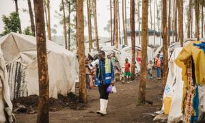A community health worker walks through an IDP camp in North Kivu in eastern Democratic Republic of the Congo.