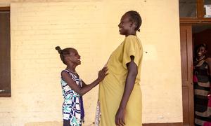 A pregnant woman and her daughter wait outside a UNICEF-supported maternity ward in South Sudan.