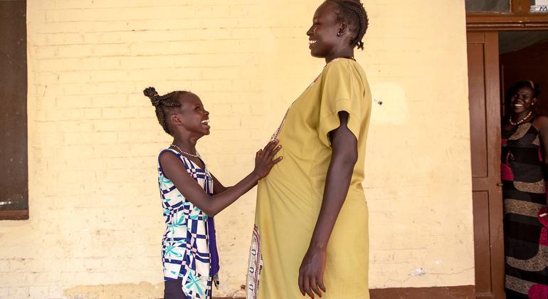 A pregnant woman and her daughter wait outside a UNICEF-supported maternity ward in South Sudan.