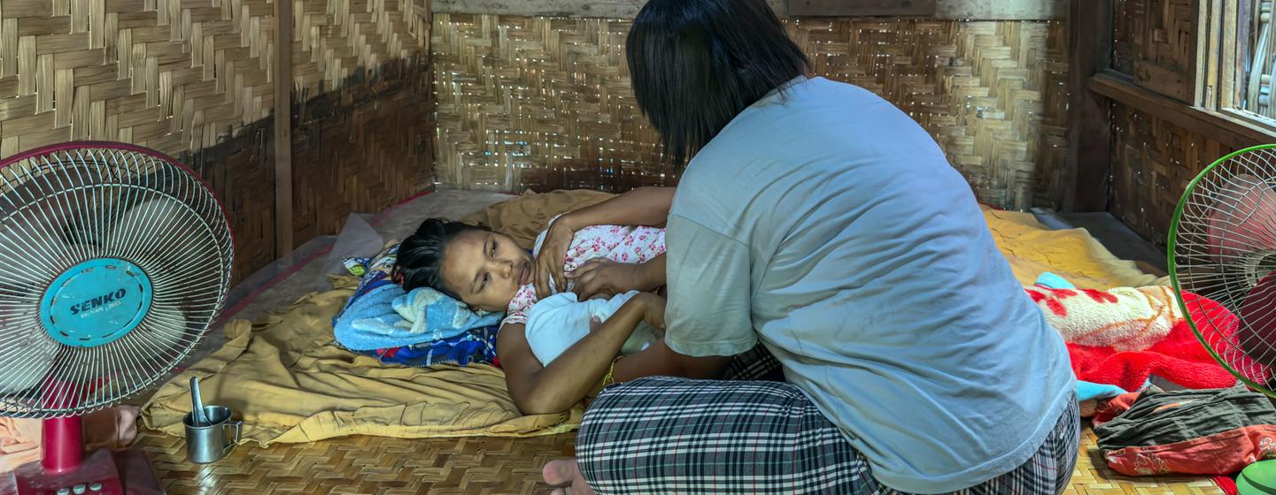 Yu Yu, a midwife, provides care for a newborn baby and the mother after her delivery in an emergency. Yu Yu, a midwife, provides care for a newborn baby and the mother after her delivery in an emergency.