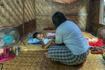 Yu Yu, a midwife, provides care for a newborn baby and the mother after her delivery in an emergency.