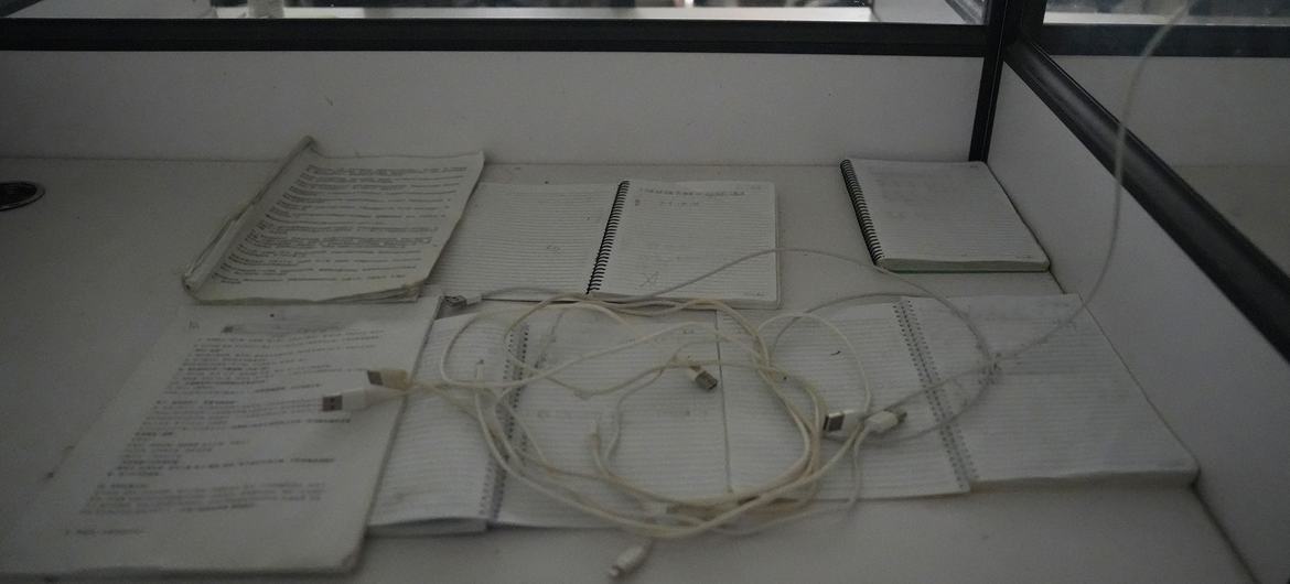 Scripts used by a worker to engage with victims lie on desk at a scam farm raided by the authorities.
