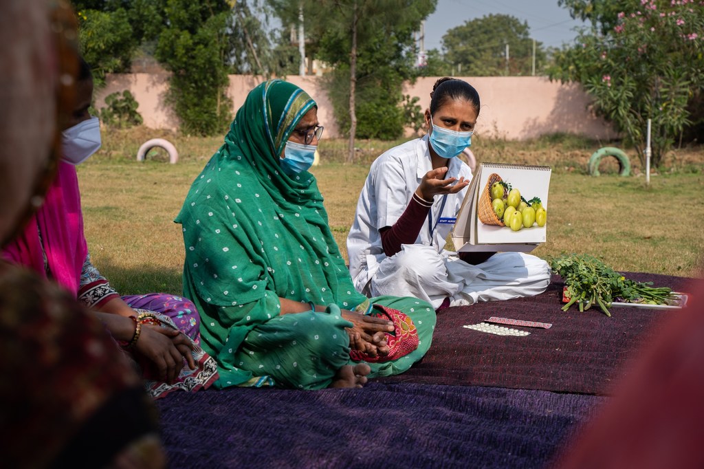 Una enfermera habla sobre nutrición a mujeres del distrito de Sabarkantha, en el oeste de India, donde muchas mujeres y niñas padecen anemia.
