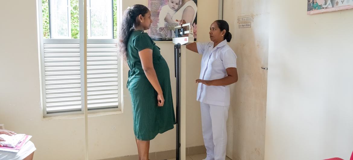 A nurse checks a pregnant woman's weight and vital signs at a clinic in Galigamuwa, Sri Lanka. A nurse checks a pregnant woman's weight and vital signs at a clinic in Galigamuwa, Sri Lanka.