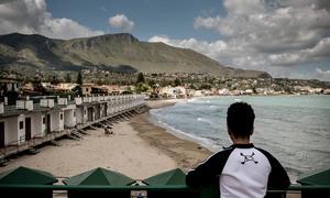 A young migrant boy looks across a bay in Italy. (file)