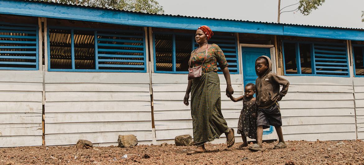 A mother and two children walk through a camp for displaced people in Goma, in the eastern DR Congo