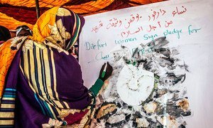 Women play a central role in building and sustaining peace. Pictured here, a woman signs a pledge to bring stability, opportunity and peace to her communities in Darfur. (file)