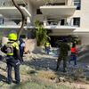 Rescue workers attend a damaged residential block in southern Israel.