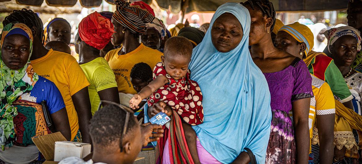 Women line up to receive beneficiary cards to buy fortified flour to prevent malnutrition in Kongoussi, Burkina Faso.