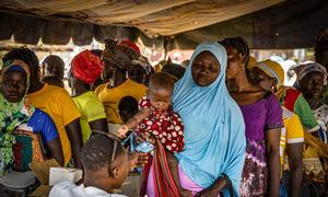 Women line up to receive beneficiary cards to buy fortified flour to prevent malnutrition in Kongoussi, Burkina Faso.