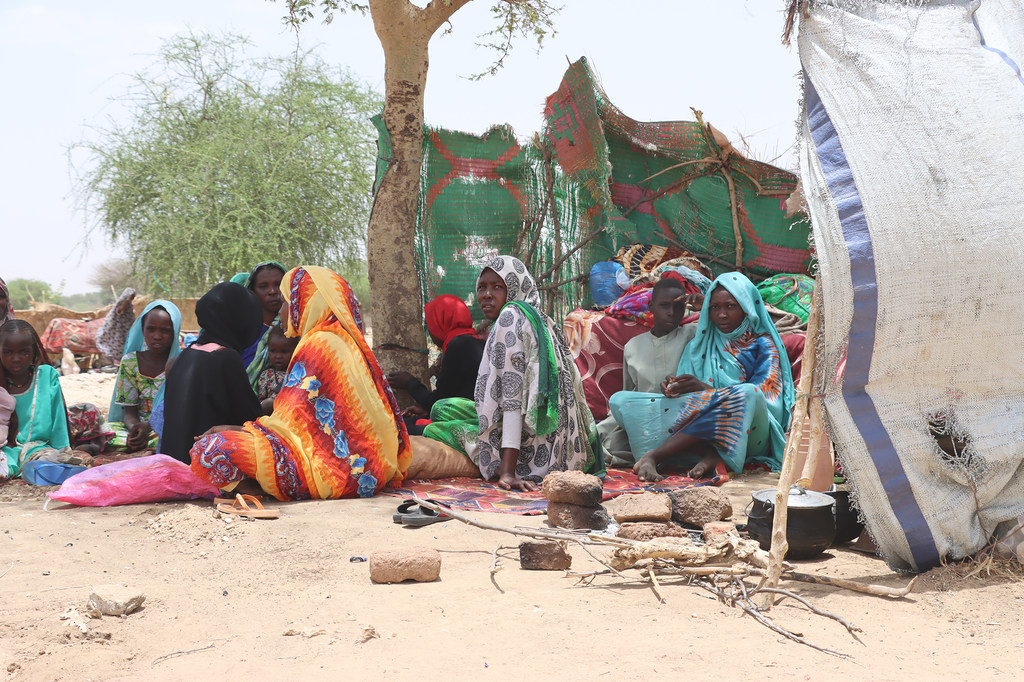 Des réfugiés soudanais qui ont fui le conflit au Soudan sont assis dans des abris de fortune à Koufron, au Tchad.