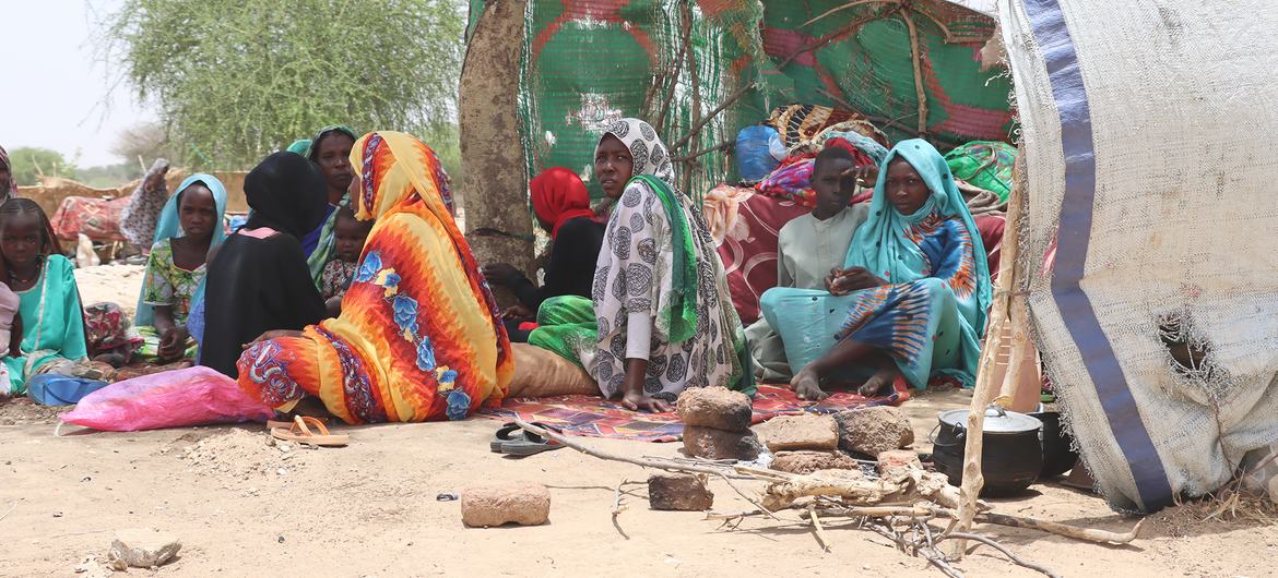 Sudanese refugees who fled the conflict in Sudan sit in makeshift shelters in Koufron, Chad.