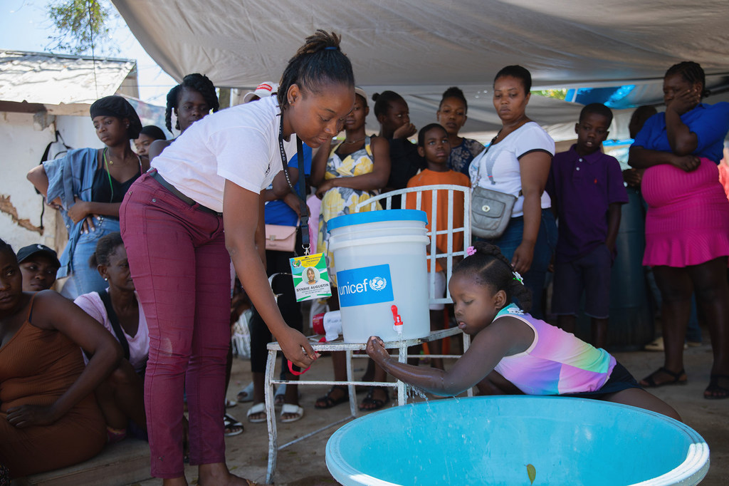 A girl from Port-au-Prince, Haiti, learns about the importance of washing her hands for her health.