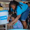 A mother and daughter attend a handwashing training session in Port-au-Prince, Haiti.