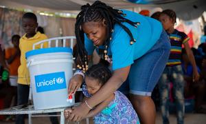 A mother and daughter attend a handwashing training session in Port-au-Prince, Haiti.