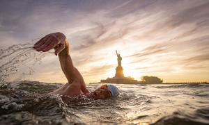 In this file photo, UNEP Patron of the Oceans Lewis Pugh swims in front of the Statue of Liberty in New York harbour (file).. 