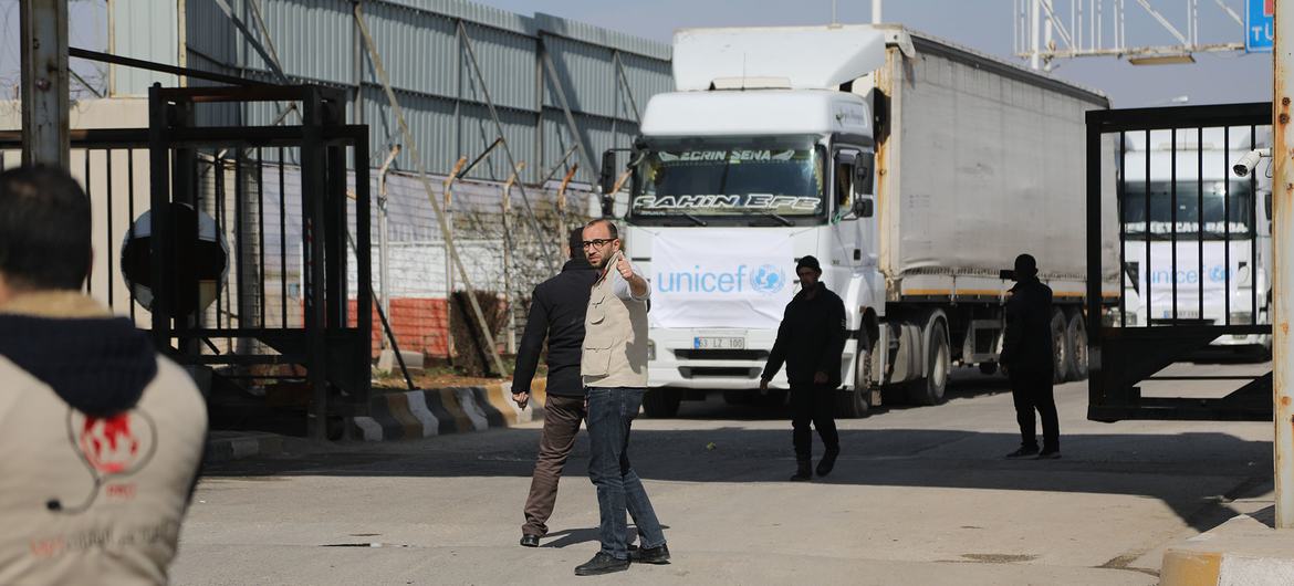 Trucks carrying essential humanitarian supplies travel from Türkiye through the Bab al-Salam border crossing, into northwest Syria.