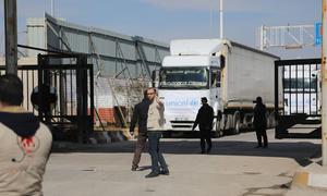 Trucks carrying essential humanitarian supplies travel from Türkiye through the Bab al-Salam border crossing, into northwest Syria.