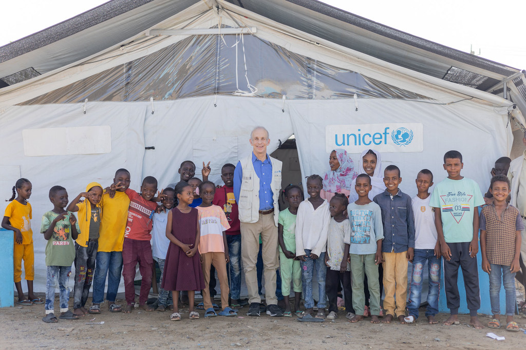 Le Représentant de l'UNICEF au Soudan, Sheldon Yett, lors de sa première mission sur le terrain dans le pays, échange avec des enfants au point de rassemblement des personnes déplacées d'Abdullah Naj, à Port-Soudan.