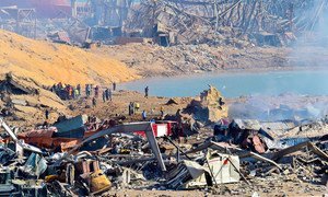 Workers in Lebanon assess the damage at Beirut Port after a deadly explosion on 4 August 2020.