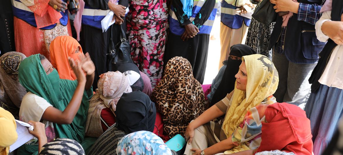 Leila Baker, UNFPA Regional Director for Arab States, stands among a group of displaced women in a safe space in Port Sudan.