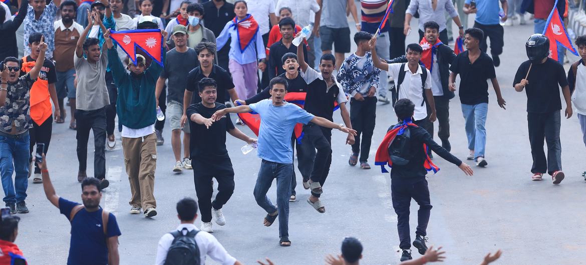 Protesters march through Kathmandu on Monday, holding signs denouncing corruption and nepotism. The protest was met with a violent crackdown that left at least 19 people dead.
