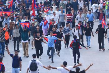 Protesters march through Kathmandu on Monday, holding signs denouncing corruption and nepotism. The protest was met with a violent crackdown that left at least 19 people dead.
