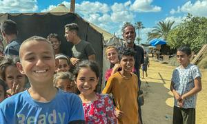 Children queue for food at a community kitchen in Deir al Balah, Gaza, prior to the ceasefire agreement.