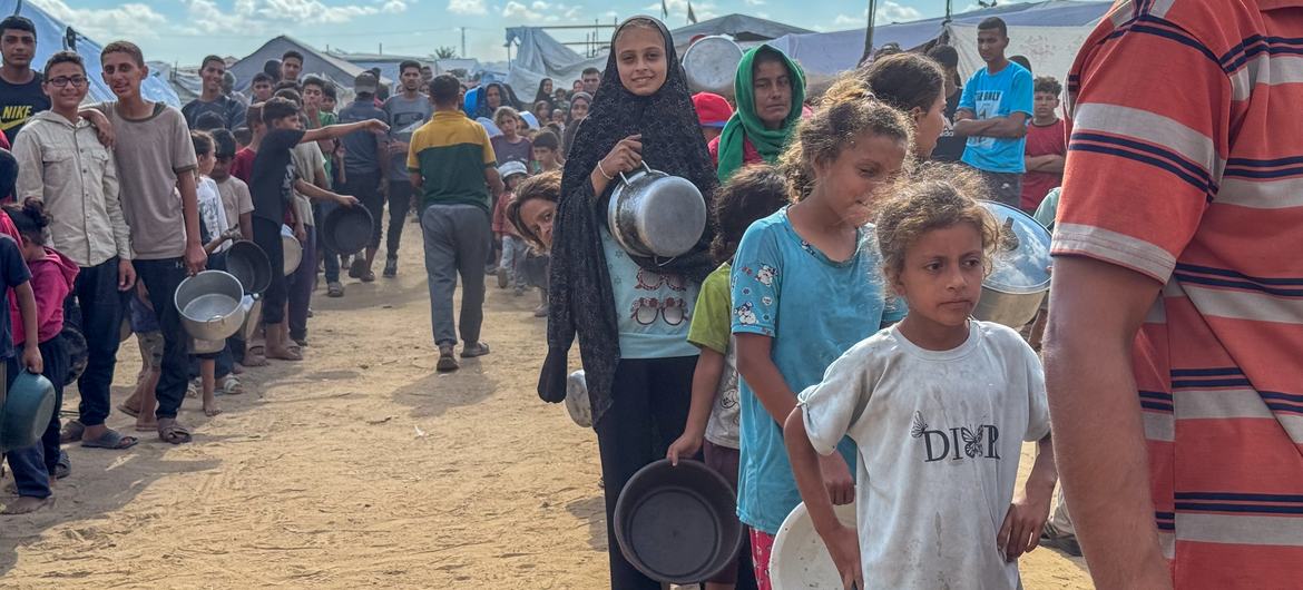 Antes del acuerdo de alto el fuego, los habitantes de Gaza hacen cola para recibir comida en un comedor comunitario en Deir al Balah. Antes del acuerdo de alto el fuego, los habitantes de Gaza hacen cola para recibir comida en un comedor comunitario en Deir al Balah.