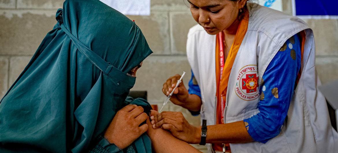A teenage girl receives her second dose of the COVID-19 vaccine in Bhasan Char in Bangladesh.
