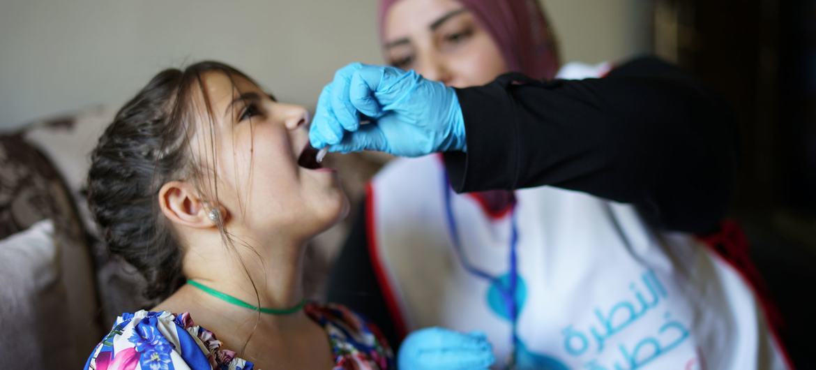 A young girl receives her measles vaccination in Lebanon.