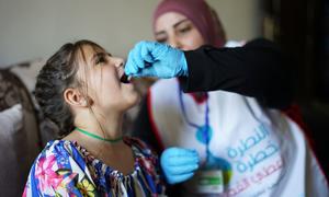 A young girl receives her measles vaccination in Lebanon.