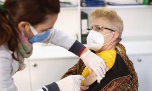 Pensioner Xhane Grodani who lives with her husband in Tirana, Albania, receives her third COVID-19 vaccination at a clinic in the capital.