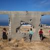 Children gather at a destroyed building in Al Nuseirat, in central Gaza.