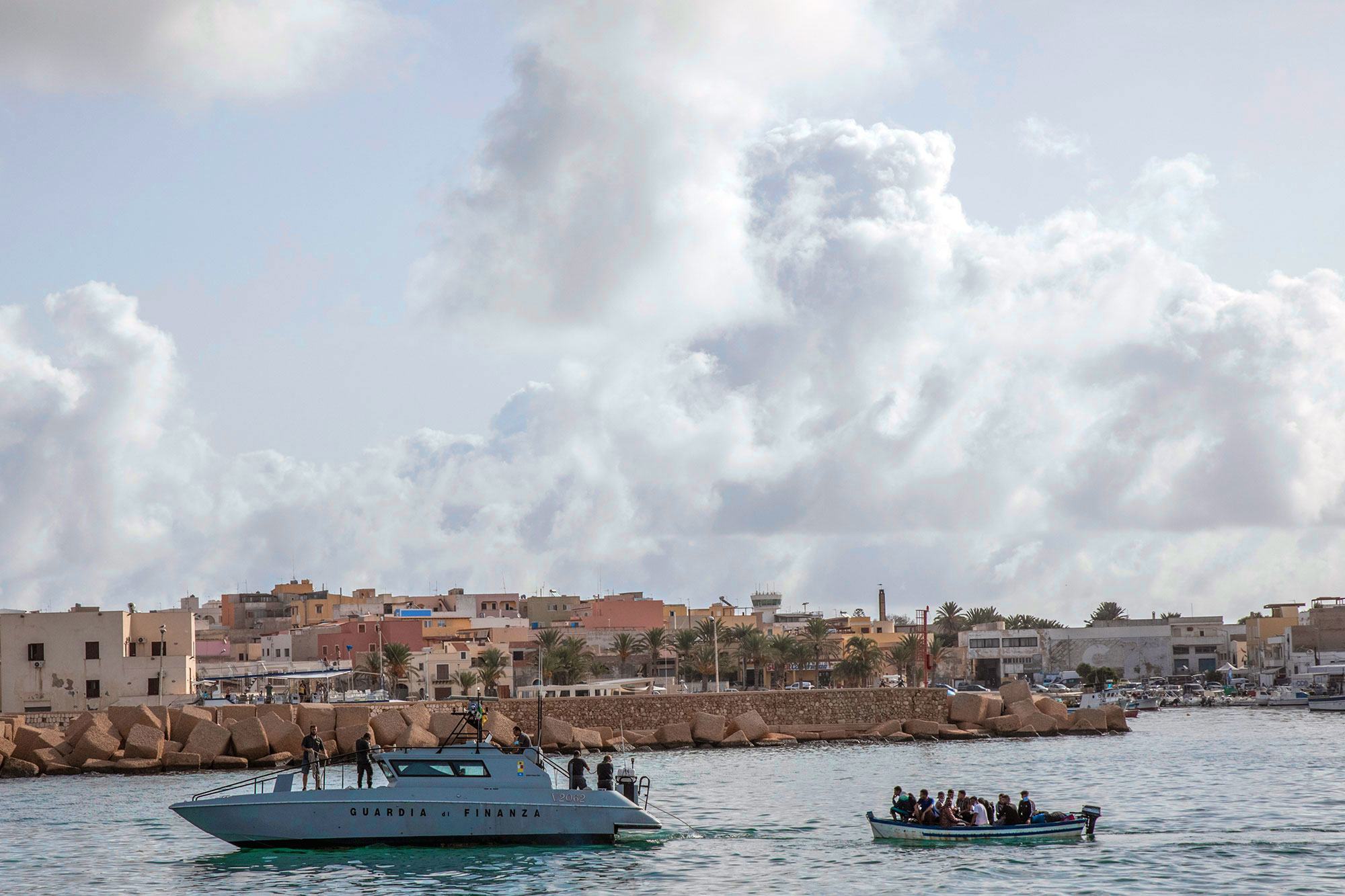Refugees and migrants in a wooden boat are rescued near the Italian island of Lampedusa in the Mediterranean Sea.
