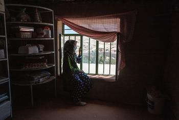 Une femme de 31 ans est assise près de la fenêtre. Elle était cheffe d'entreprise avant la prise de pouvoir par les Talibans.