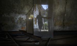 The silhouette of a 15-year-old child on crutches. He lost his left leg after accidentally stepping on a landmine in a rice field.