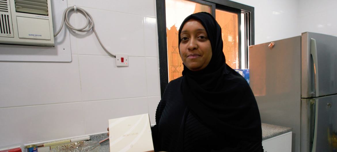 After baking her cookies, Eman Fareed packages them in an attractive box branded with her business name.